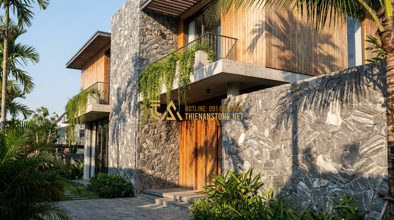 Tạo ảnh tiếng Anh: An exterior shot of a modern villa featuring a combination of wood cladding and large irregular natural stone walls. The stone is a light grey and beige granite, textured and rugged. Green vines hang from the balcony. Sunlight creates sharp shadows, highlighting the architectural layers. 8k resolution, cinematic lighting.