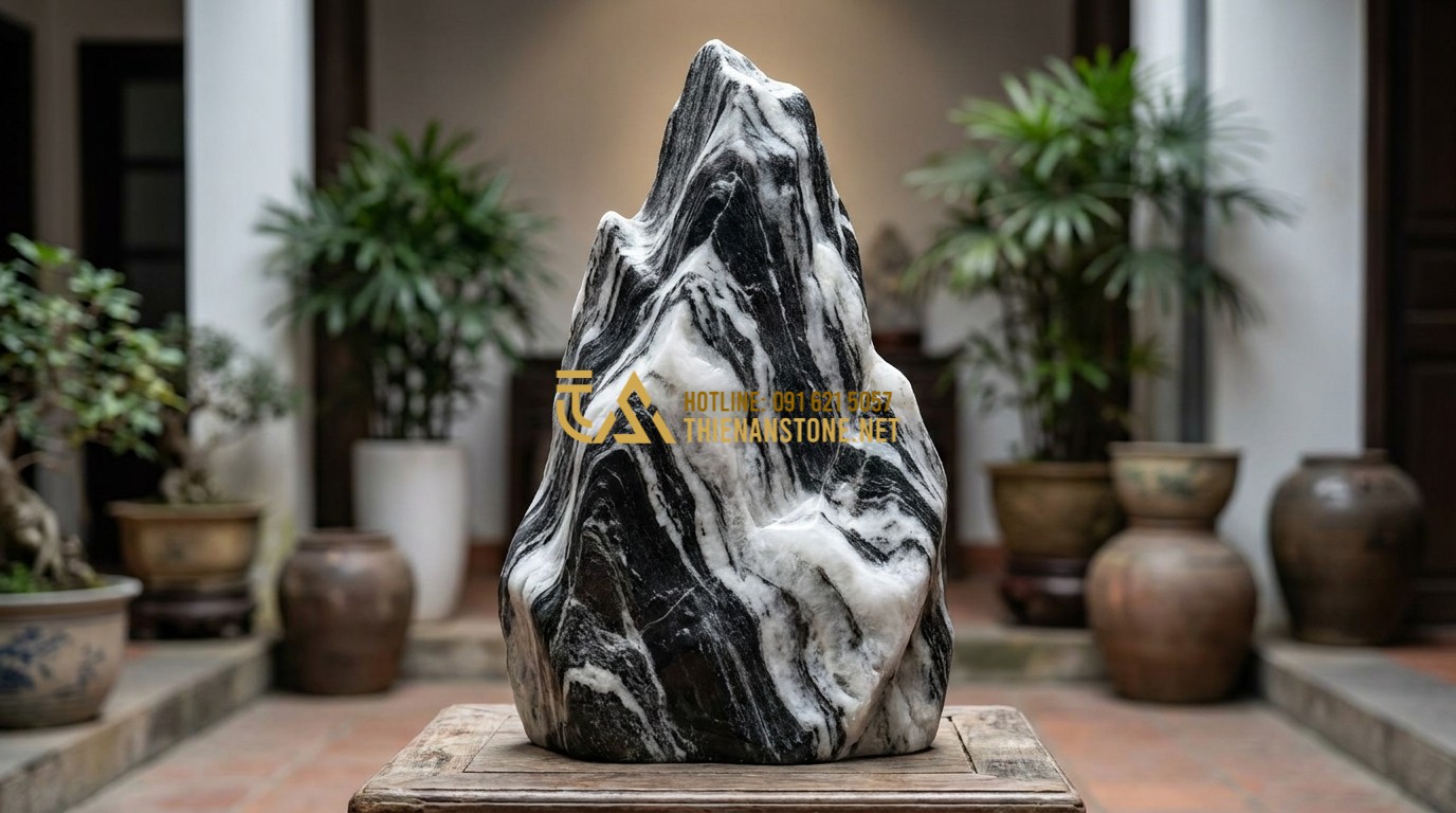 Tạo ảnh tiếng Anh: Close-up professional photograph of a high-quality Tuyet Son stone, showcasing dramatic black and white marble-like veins that look like snowy mountain peaks. The lighting is soft and cinematic, highlighting the natural textures and crystalline structure of the rock. 8k resolution, architectural style.