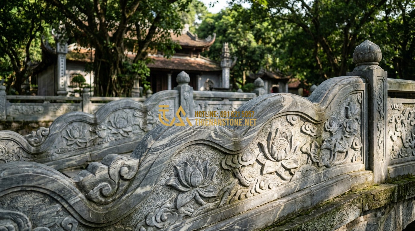 Tạo ảnh tiếng Anh: A grand and ancient stone balustrade surrounding a traditional Vietnamese temple, intricate carvings of lotus flowers and clouds on the grey stone surfaces, sunlight filtering through green trees, professional architectural photography, 8k resolution.