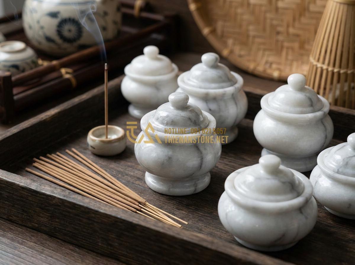 Tạo ảnh tiếng Anh: Close-up professional image of various natural stone incense burners in different colors and patterns, showcasing unique marble and granite textures, polished surfaces reflecting soft light, arranged elegantly on wooden surface with incense sticks nearby, high detail, studio lighting, luxurious and natural aesthetic