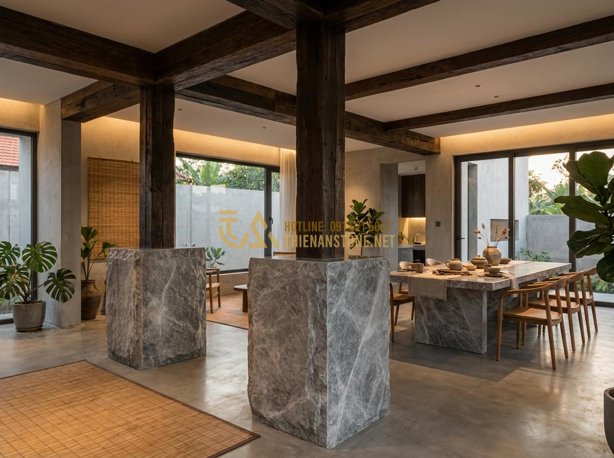 Create a realistic lifestyle photograph of a modern Vietnamese villa interior featuring natural stone pedestals (chân tảng đá) supporting wooden beams, combined with a stone dining table in the background, warm ambient lighting, luxurious yet cozy atmosphere, wide angle shot, professional interior design photography 8k resolution