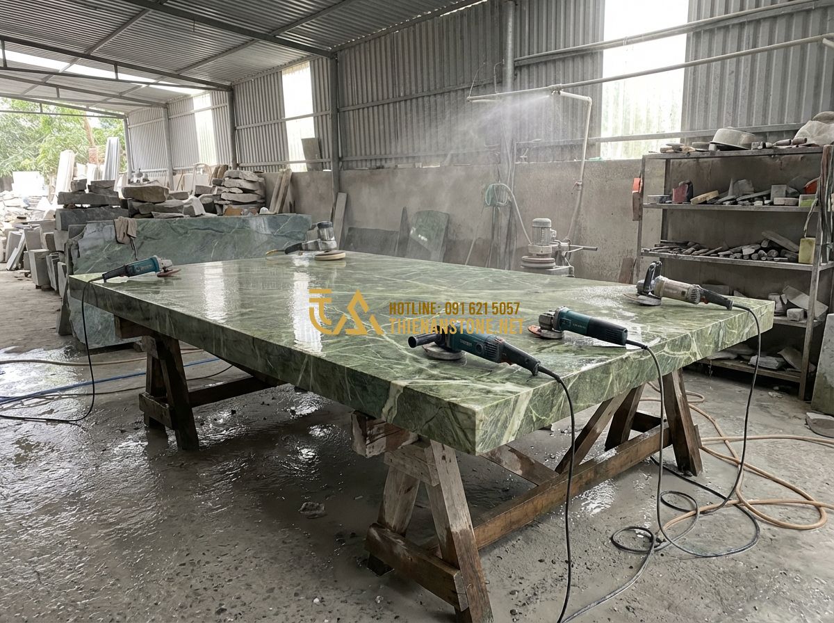 1 Bộ Bàn Ghế Đá Tự Nhiên Bao Nhiêu Tiền? Bảng Giá Cập Nhật Mới Nhất - Hình 2 1 Bộ Bàn Ghế Đá Tự Nhiên Bao Nhiêu Tiền? Bảng Giá Cập Nhật Mới Nhất - A professional workshop scene where skilled artisans are carefully polishing a m
