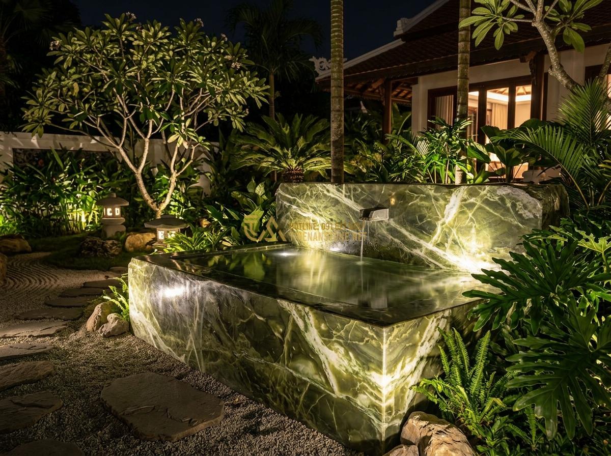 Ang Nước Bằng Đá Nguyên Khối Có Tốt Không? Ưu Nhược Điểm Thực Tế 2026 - Night view of illuminated monolithic natural stone water basin in a high-end vil