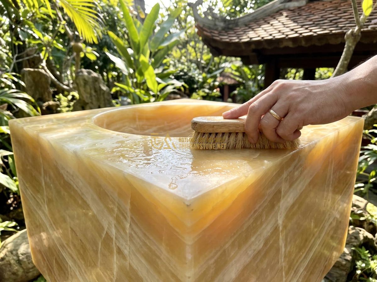 Ang Nước Bằng Đá Nguyên Khối Có Tốt Không? Ưu Nhược Điểm Thực Tế 2026 - Maintenance process showing gentle cleaning of monolithic stone water basin surf