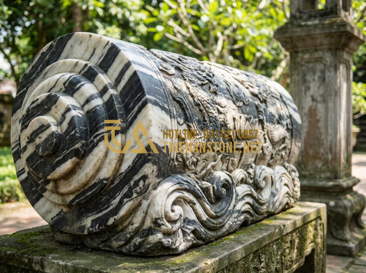 Báo Giá Cuốn Thư Đá Lăng Mộ Mới Nhất: Bảng Giá Tại Xưởng Năm 2026 - Hình 9 Báo Giá Cuốn Thư Đá Lăng Mộ Mới Nhất: Bảng Giá Tại Xưởng Năm 2026 - Close-up of polished granite stone scroll with deep carvings and natural speckle