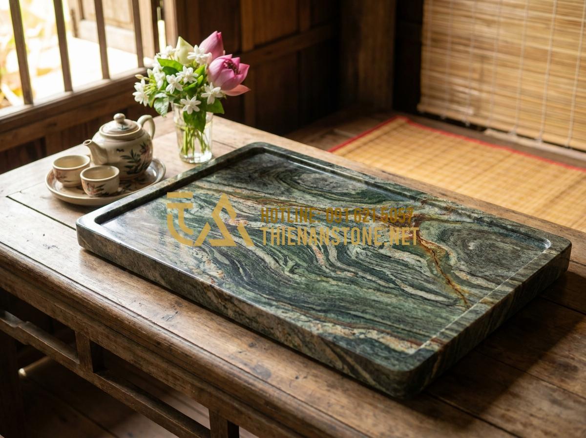 Báo Giá Khay Trà Đá Tự Nhiên Mới Nhất - Mua Khay Trà Đá Ở Đâu Uy Tín? - Hình 1 Báo Giá Khay Trà Đá Tự Nhiên Mới Nhất - Mua Khay Trà Đá Ở Đâu Uy Tín? - High-resolution close-up of a polished natural granite tea tray with intricate n