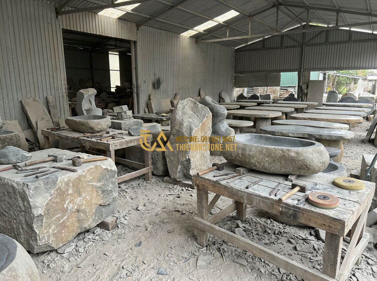 Cách Chọn Bàn Ghế Đá Tự Nhiên Nguyên Khối Đúng Chuẩn - Hướng Dẫn Chi Tiết 2024 - Tạo ảnh tiếng Anh: A large stone masonry workshop with skilled artisans carving