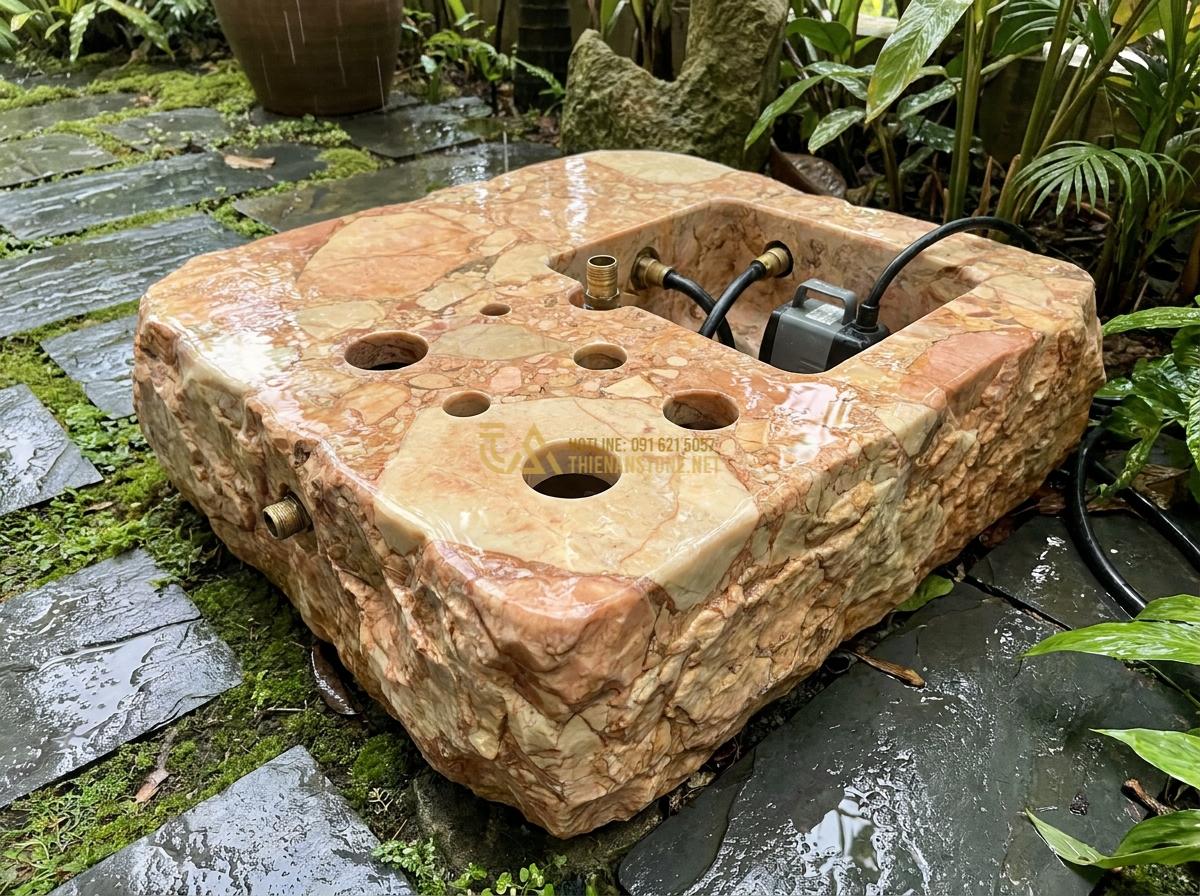 Cấu Tạo Đài Phun Nước Bằng Đá Tự Nhiên & Nguyên Lý Hoạt Động Chi Tiết - Hình 1 Cấu Tạo Đài Phun Nước Bằng Đá Tự Nhiên & Nguyên Lý Hoạt Động Chi Tiết - Close-up view of a natural stone fountain base carved from a single granite bloc