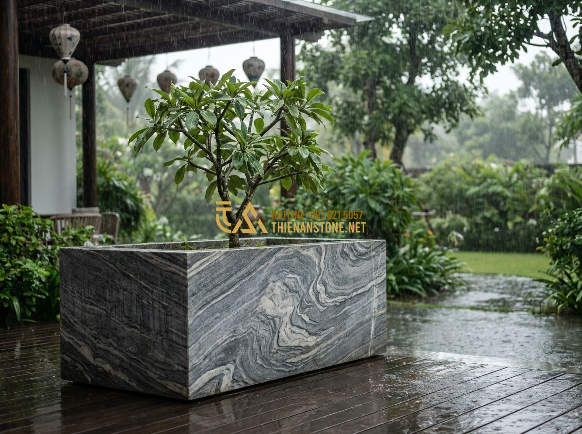 Chậu Đá Tự Nhiên Trồng Cây Cảnh Cao Cấp: Đặc Điểm, Ưu Điểm & Ứng Dụng Trang Trí Không Gian Xanh - A luxury villa patio during a rainstorm, a sturdy natural stone planter holding