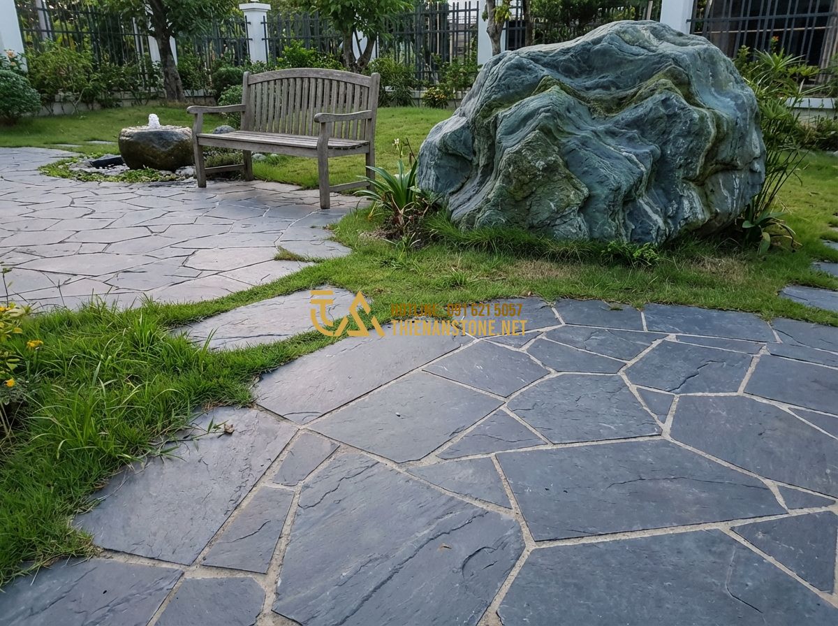 Đá Rối Lát Sân Vườn Đẹp: Hướng Dẫn Lát Sân + Báo Giá Đá Rối Lát Sân Mới Nhất 2026 - Tạo ảnh tiếng Anh: A wide shot of a completed garden patio paved with dark grey
