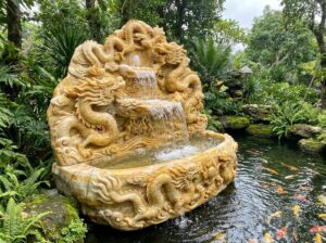 Đài Phun Nước Bằng Đá Phong Thủy: Ý Nghĩa, Cách Bố Trí & Lợi Ích Mang Lại Tài Lộc - A highly detailed realistic photograph of a large natural stone fountain with ca