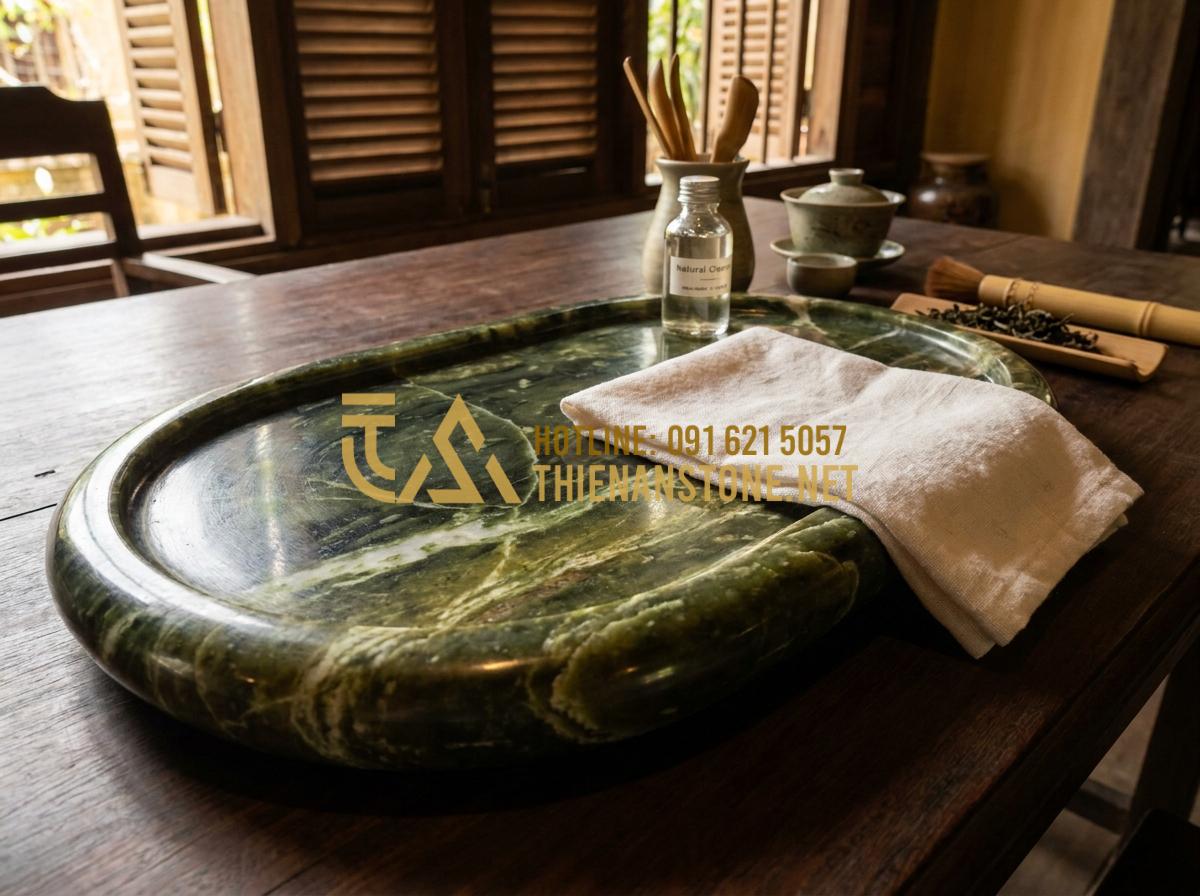 Hướng Dẫn Cách Lắp Đặt Và Xử Lý Khay Trà Đá Thoát Nước Luôn Khô Thoáng - Person gently cleaning and maintaining a dry pebble stone tea tray with soft clo