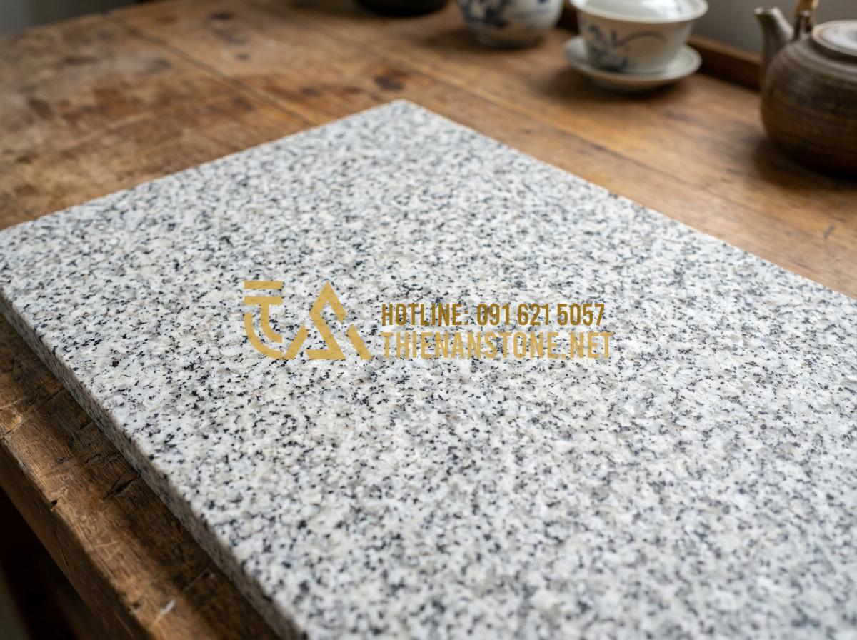 Hướng dẫn chọn mặt bàn trà bằng đá phù hợp với khung chân sắt và gỗ - Tạo ảnh tiếng Anh: Close-up of various natural stone samples: Marble, Granite, a