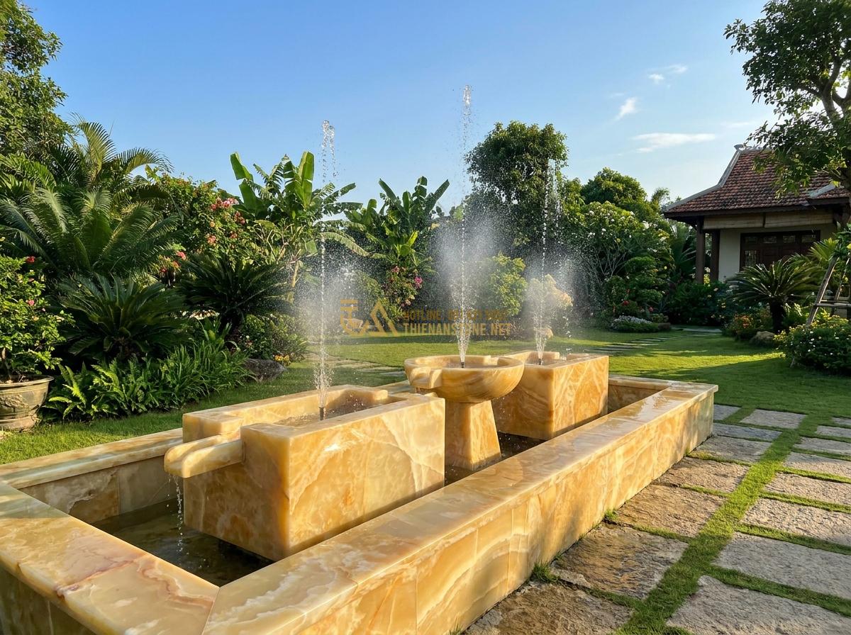 Hướng Dẫn Lắp Đặt Đài Phun Nước Bằng Đá Sân Vườn Đơn Giản Tại Nhà - Wide angle view of a modern stone garden fountain with multiple water spouts cre