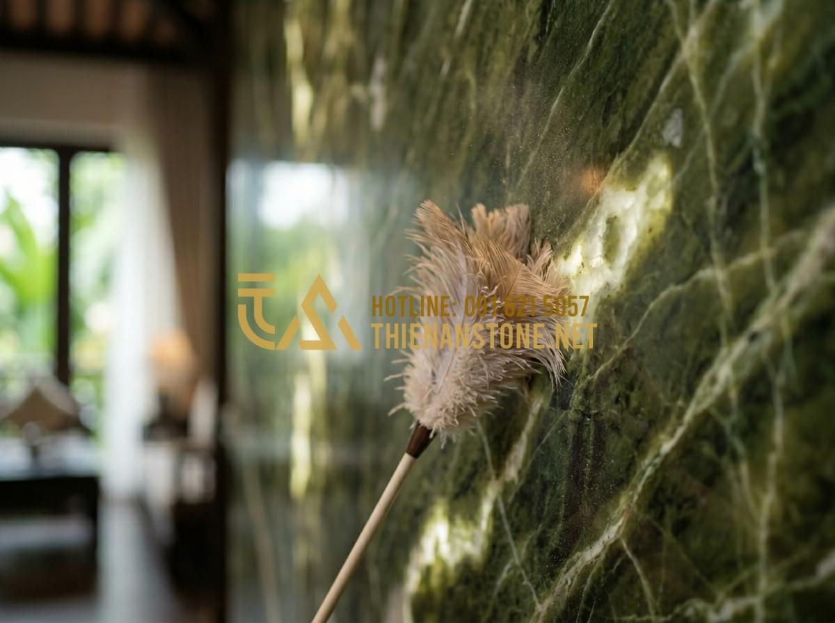 Hướng dẫn vệ sinh tranh đá tự nhiên xuyên sáng để giữ độ bóng bền lâu - Hình 4 Hướng dẫn vệ sinh tranh đá tự nhiên xuyên sáng để giữ độ bóng bền lâu - Tạo ảnh tiếng Anh: A person gently dusting a high-end backlit stone wall using a