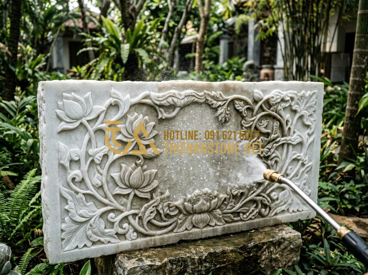 Hướng dẫn vệ sinh và bảo dưỡng phù điêu đá ngoài trời luôn như mới - Tạo ảnh tiếng Anh: A person carefully using a low-pressure water sprayer to pre-