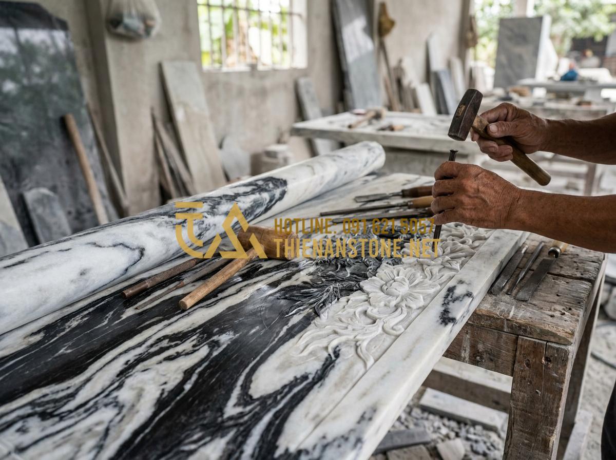 Kinh Nghiệm Lựa Chọn Và Lắp Đặt Bức Cuốn Thư Bằng Đá Bền Đẹp Vĩnh Cửu - Expert craftsman hands carving detailed patterns on a large natural stone scroll