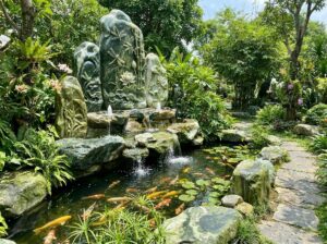 Lợi Ích Tuyệt Vời Khi Sử Dụng Đài Phun Nước Bằng Đá Trong Thiết Kế Tiểu Cảnh & Hồ Cá Koi - Elegant natural stone water fountain integrated into a lush Vietnamese garden la
