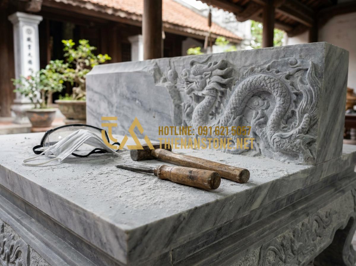 Mua Bàn Thờ Ông Địa Bằng Đá TPHCM: Top 5 Địa Chỉ Uy Tín Và Chất Lượng Nhất - A skilled artisan wearing a face mask and goggles, carefully using a chisel and