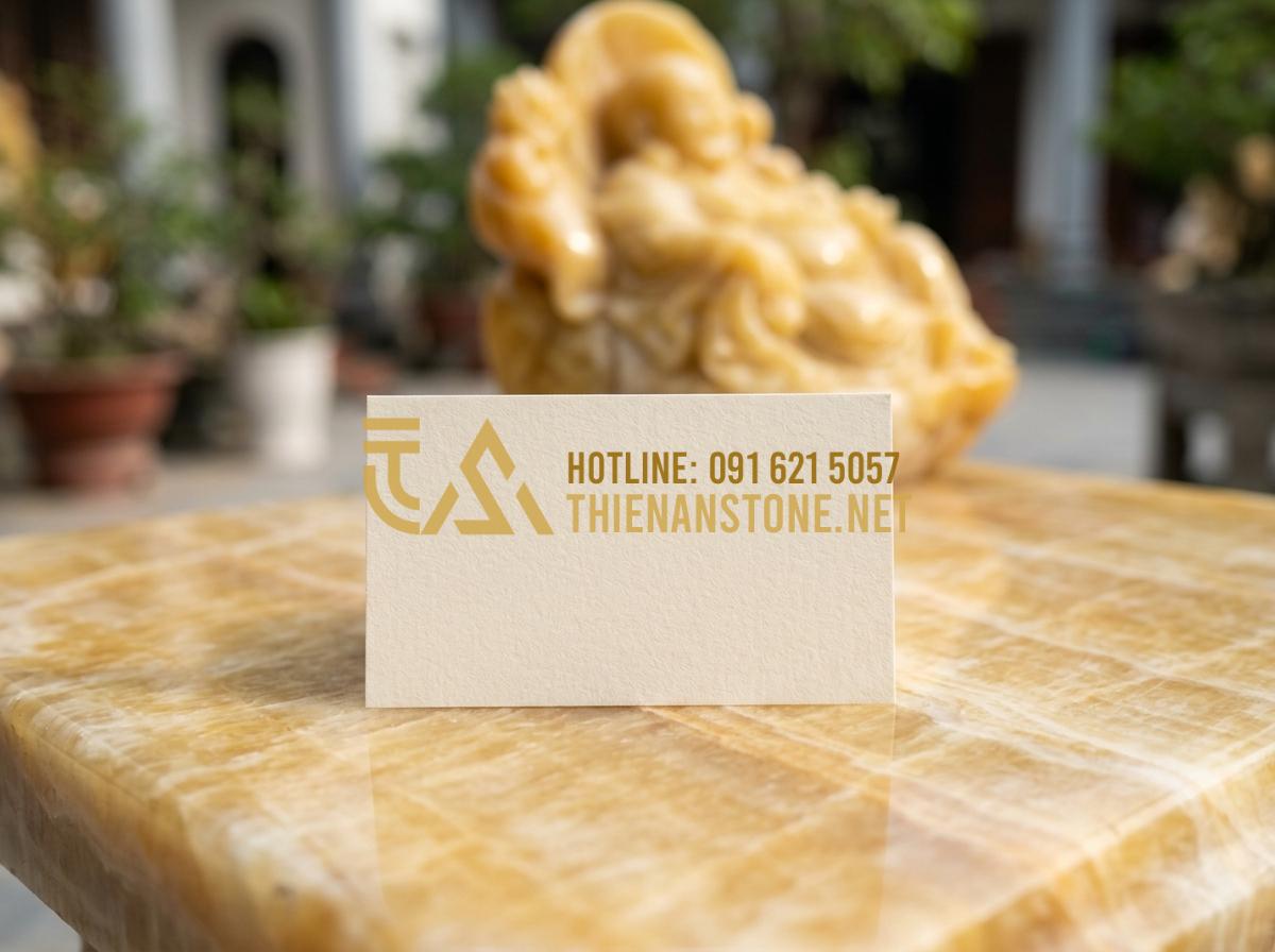 Thùng rác gạt tàn đá hoa cương: Giải pháp sang trọng cho sảnh khách sạn, tòa nhà - Hình 14 Thùng rác gạt tàn đá hoa cương: Giải pháp sang trọng cho sảnh khách sạn, tòa nhà - Tạo ảnh tiếng Anh: A professional business card of Thien An Stone placed on a po