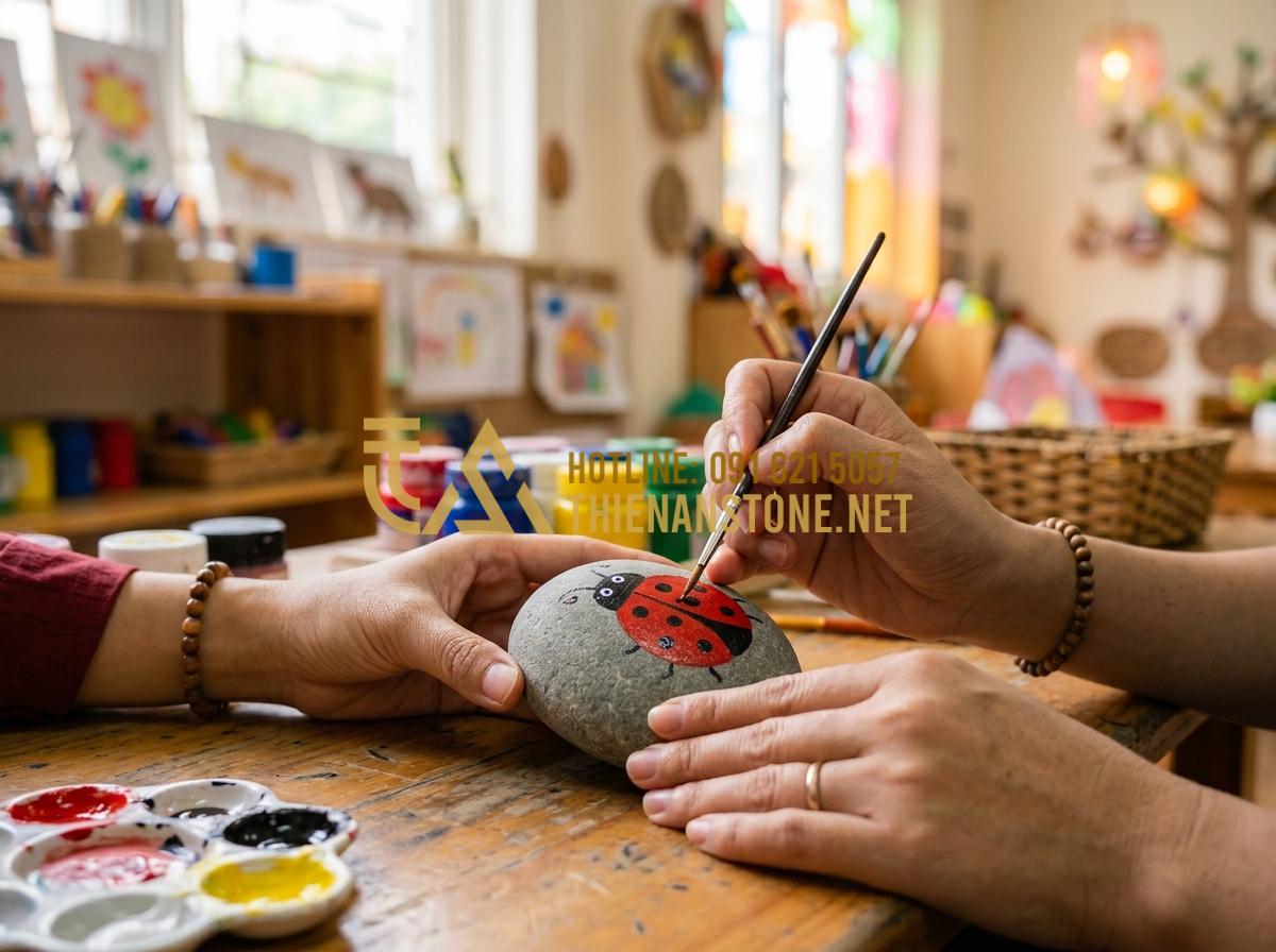 Tranh đá cuội mầm non: Ý tưởng sáng tạo sỏi đá cho không gian giáo dục - Tạo ảnh tiếng Anh: A professional close-up photo of a preschool teacher's hands