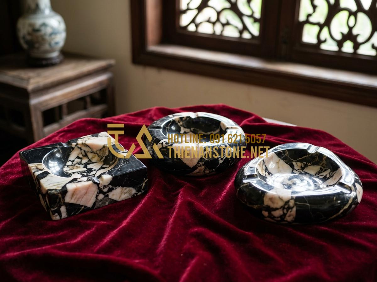 Ý nghĩa phong thủy của gạt tàn đá trên bàn làm việc của doanh nhân - Tạo ảnh tiếng Anh: A collection of different types of stone ashtrays displayed o