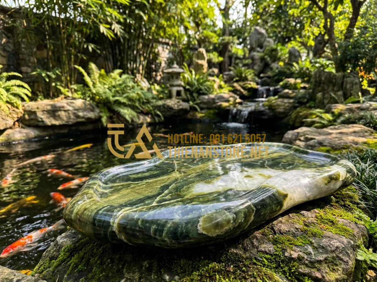 Ý Nghĩa Phong Thủy Của Khay Trà Đá: Cách Chọn Màu Đá Hợp Mệnh Gia Chủ - Large stone tea tray placed near Koi pond in a Vietnamese garden setting with ro